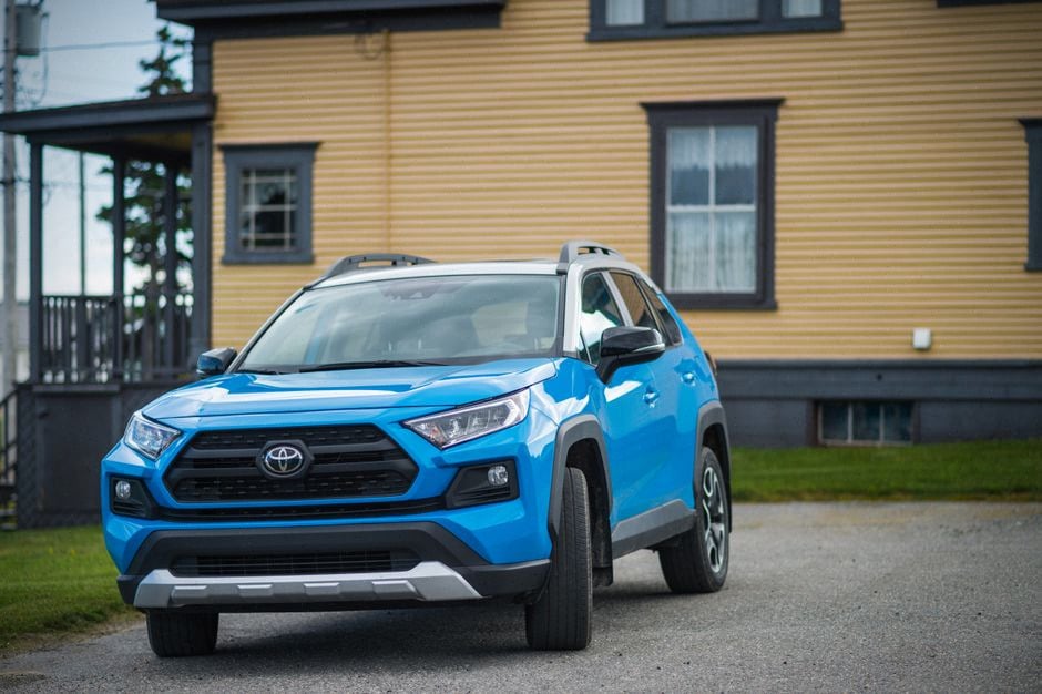 SUV compact et berline familiale devant une maison américaine récente